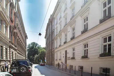 a car parked on a street between two buildings at HOUSEHOST Apartment :Zacisze Street in Kraków