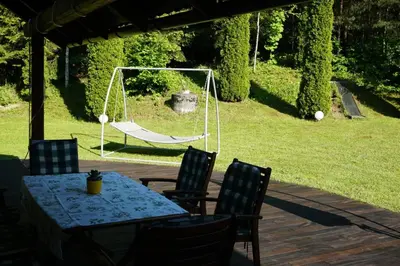 a table and chairs with a swing in a yard at Villa Barwald in Barwałd Górny