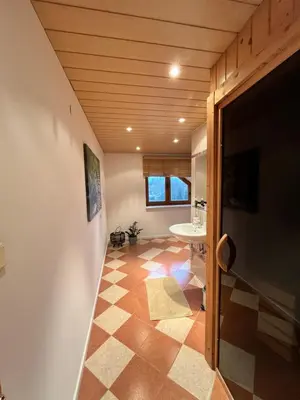 a bathroom with a tiled floor and a sink at Villa Barwald in Barwałd Górny