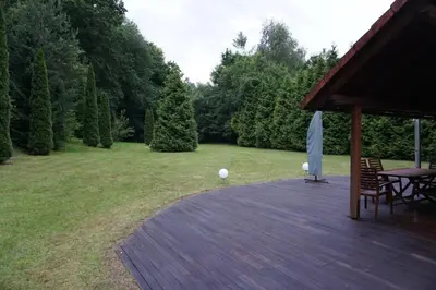 a wooden deck with a table and a picnic table at Villa Barwald in Barwałd Górny