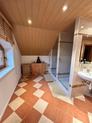 a large bathroom with a shower and a sink at Villa Barwald in Barwałd Górny