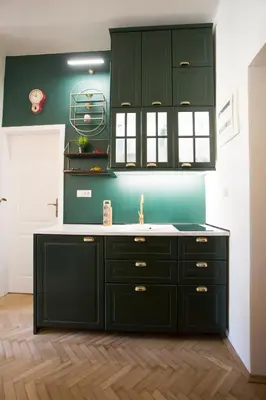 a kitchen with green cabinets and a sink at Krakowska 5 in Kraków