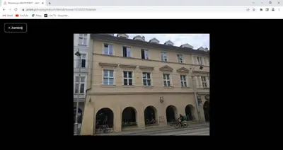 a building with a person riding a bike in front of it at Krakowska 5 in Kraków