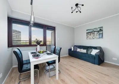 a living room with a table and a couch at P&P Apartments in Kraków