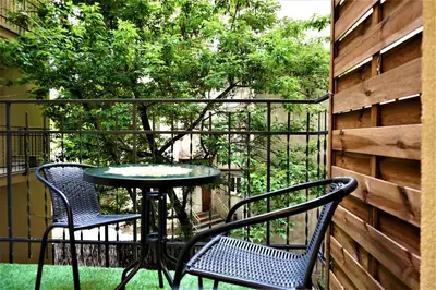 two chairs and a table on a balcony at Luxury Jacuzzi Apartment in Kraków