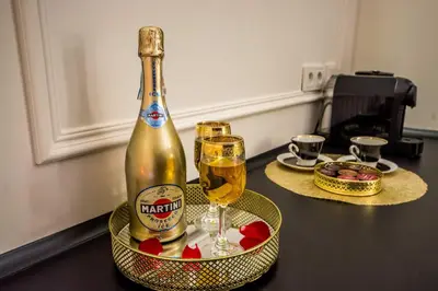 a bottle of champagne and a glass on a table at Luxury Jacuzzi Apartment in Kraków