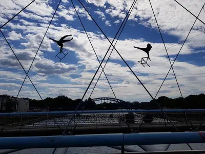 two people are jumping on skis in the water at Cracowapart Hugo in Kraków
