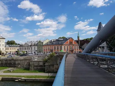 a bridge over a river in a city with buildings at Cracowapart Hugo in Kraków