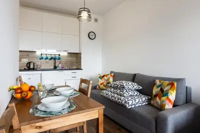 a living room with a couch and a table at ENERGYLANDIA Zator Apartament Madzia in Zator