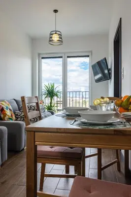 a living room with a dining room table with a view at ENERGYLANDIA Zator Apartament Madzia in Zator