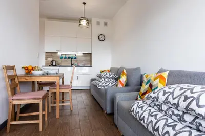 a living room with a couch and a table at ENERGYLANDIA Zator Apartament Madzia in Zator