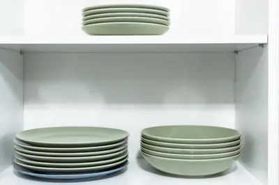 two stacks of plates sitting on a shelf at ENERGYLANDIA Zator Apartament Madzia in Zator