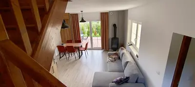 a dog laying on a couch in a living room at Domki pod Groniem in Kasina Wielka