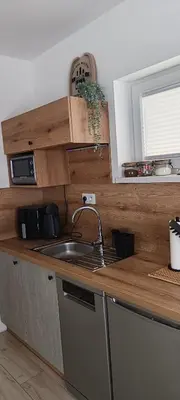 a kitchen with a sink and a counter top at Domki pod Groniem in Kasina Wielka
