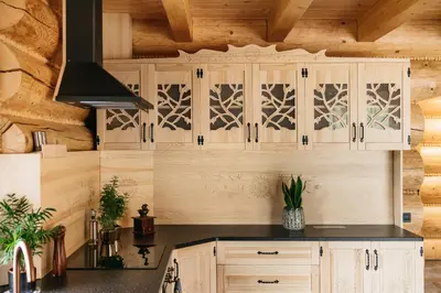 a kitchen with wooden cabinets and a ceiling at NA BALI po góralsku in Poręba Wielka