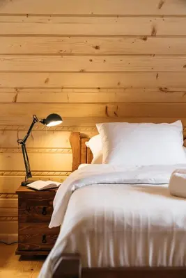 a bedroom with a bed and a desk with a lamp at NA BALI po góralsku in Poręba Wielka