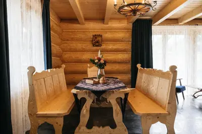 a dining room with a table and two chairs at NA BALI po góralsku in Poręba Wielka