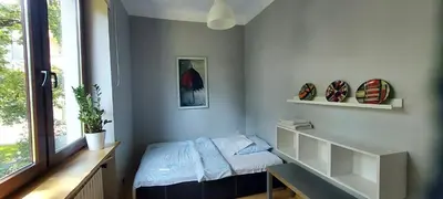 a small room with a bed and a window at Hidden Gem Garden in Kraków