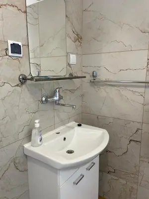 a bathroom with a white sink and a mirror at Pensjonat Południe in Wieliczka