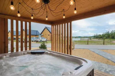 a jacuzzi tub in a porch with a view at Wierzbowa przystań in Czchów