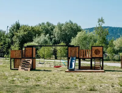 a playground with two benches and a slide at Wierzbowa przystań in Czchów