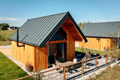 a log cabin with a porch and a roof at Wierzbowa przystań in Czchów