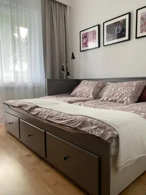 a bedroom with a large bed with two pillows at Apartament Podłęska in Kraków