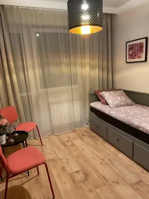 a bedroom with a bed and a table and chairs at Apartament Podłęska in Kraków