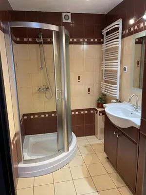 a bathroom with a shower and a sink at Apartament Podłęska in Kraków