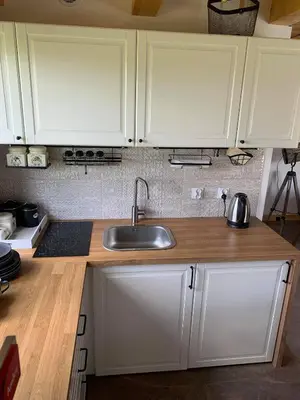 a kitchen with white cabinets and a sink at Siedlisko Przyjazne Progi in Rusocice