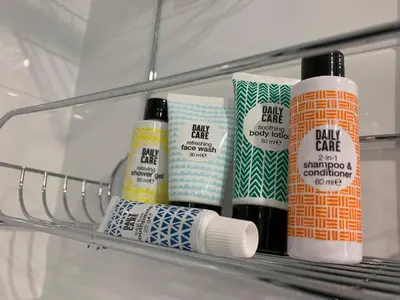 a shelf with four bottles of hair products on it at Siedlisko Przyjazne Progi in Rusocice