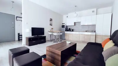 a living room with a couch and a table at Piłsudskiego 11 by Homeprime in Kraków
