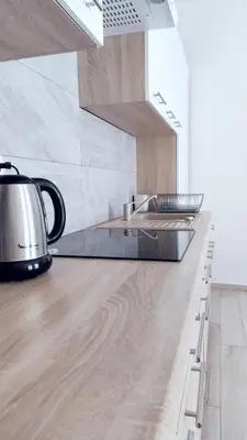 a kitchen with a sink and a stove top oven at Piłsudskiego 11 by Homeprime in Kraków