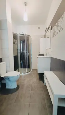 a bathroom with a shower and a toilet and a sink at Piłsudskiego 11 by Homeprime in Kraków