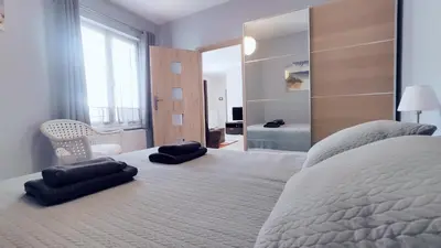 a bedroom with a large bed with two pillows on it at Piłsudskiego 11 by Homeprime in Kraków