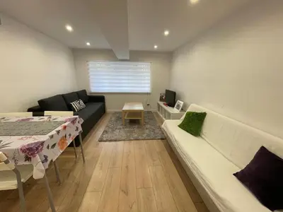 a living room with a couch and a table and a couch at Rzeszowska Apt 01 in Kraków