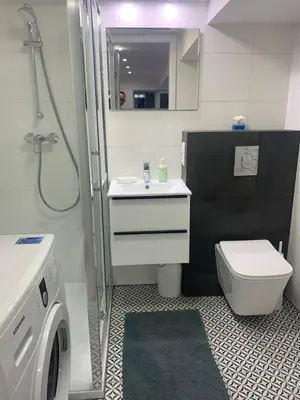 a bathroom with a shower and a toilet and a sink at Rzeszowska Apt 01 in Kraków