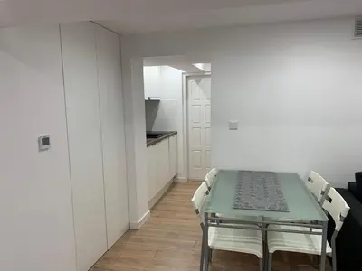 a dining room with a green table and chairs at Rzeszowska Apt 01 in Kraków
