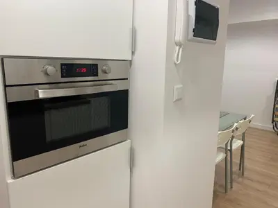 a kitchen with a refrigerator and a stove at Rzeszowska Apt 01 in Kraków
