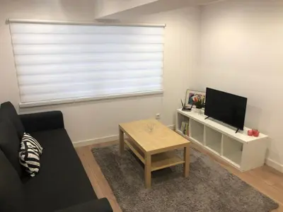a living room with a couch and a tv and a table at Rzeszowska Apt 01 in Kraków