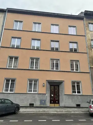 a large brick building with windows and a door at Rzeszowska Apt 01 in Kraków