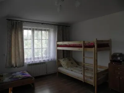 a bedroom with two bunk beds and a window at Siedlisko Pauza in Kozłów