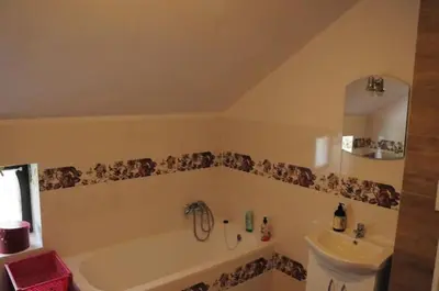 a bathroom with a bath tub and a sink at Siedlisko Pauza in Kozłów