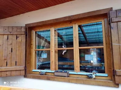 a window in a house with two birds on it at Gospodarstwo Agroturystyczne U Stasików in Spytkowice