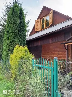 a house with a green fence in front of it at Gospodarstwo Agroturystyczne U Stasików in Spytkowice