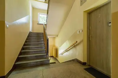 a staircase in a building with a door at Apartment Smoluchowskiego Cracow by Noclegi Renters in Kraków