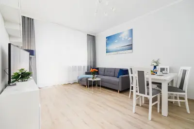 a living room with a couch and a table at Apartment Smoluchowskiego Cracow by Noclegi Renters in Kraków