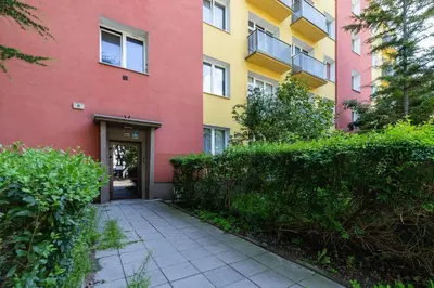 a building with a walkway in front of a building at Apartment Smoluchowskiego Cracow by Noclegi Renters in Kraków