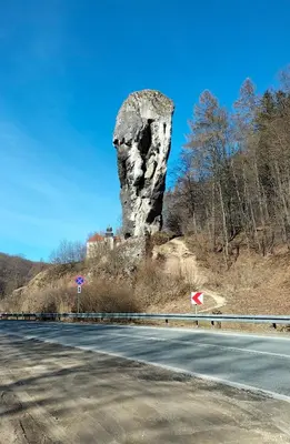a large rock formation on the side of a road at Mały domek w Dolinie Prądnika in Sułoszowa