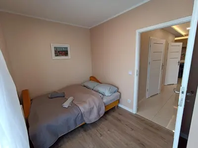 a small bedroom with a bed and a bathroom at APARTAMENTY BARSKA 69 in Kraków